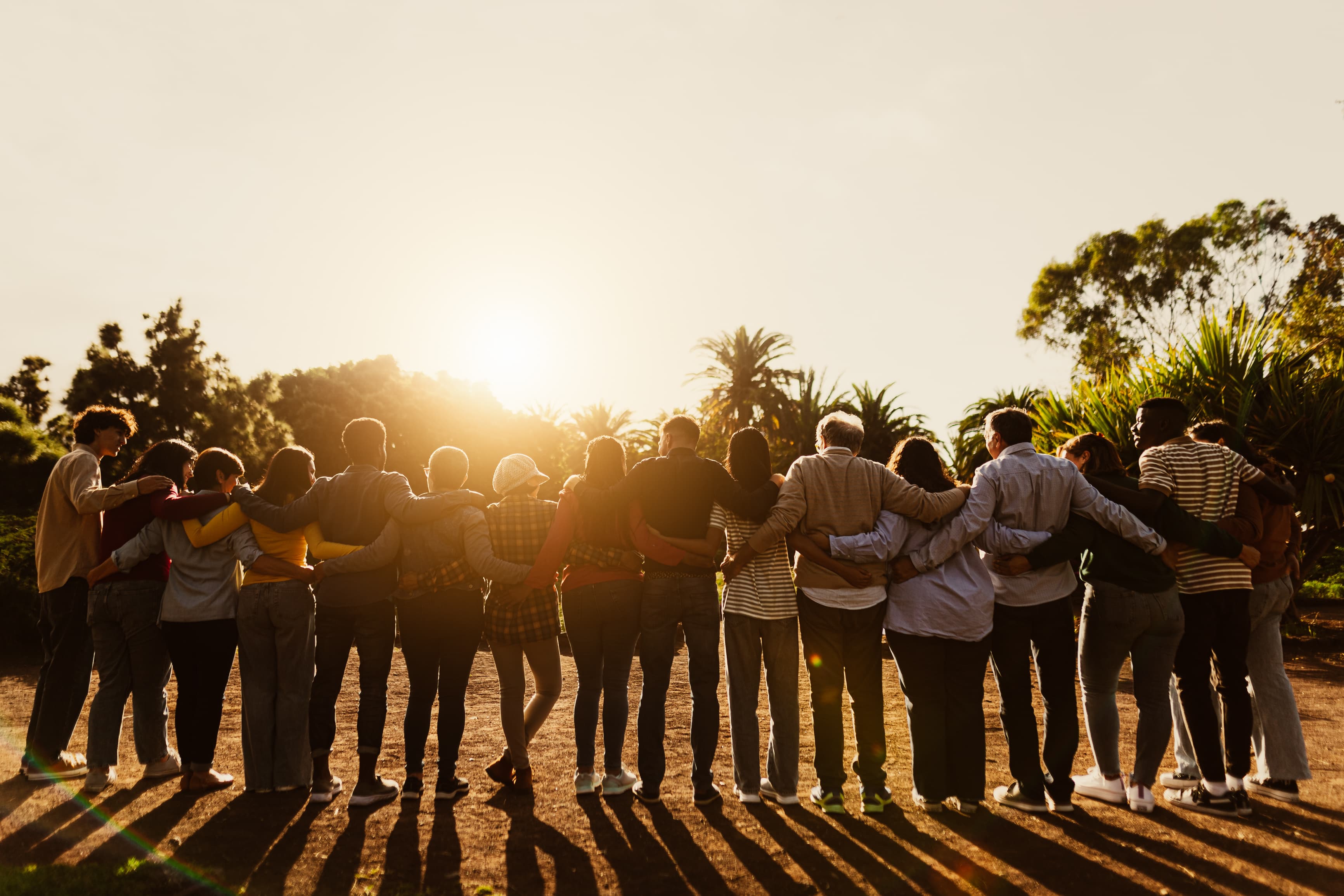 A community gathered together at sunset
